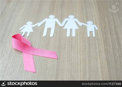 Breast Cancer Awareness, Pink Ribbon with family paper shape for supporting people living and illness. Woman Healthcare and World cancer day concept