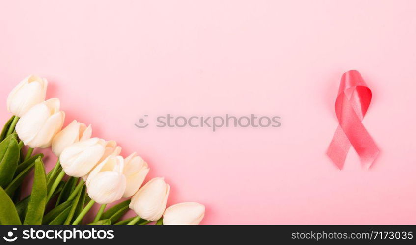 Breast cancer month concept, flat lay top view, pink ribbon and Tulip Flower on pink background with copy space for your text