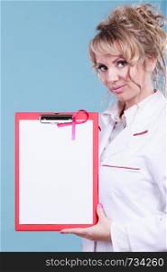 Breast cancer tumor. Mature woman doctor showing red folder with empty white paper for diagnosis. Pink ribbon of awareness on blank file.. Female doctor with folder and pink ribbon