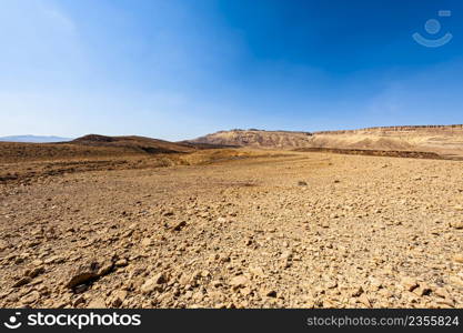 Breathtaking landscape of the rock formations in the Israel desert. Lifeless and desolate scene as a concept of loneliness, hopelessness and depression.