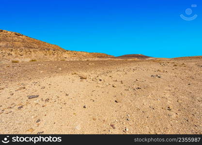 Breathtaking landscape of the rock formations in the Israel desert. Lifeless and desolate scene as a concept of loneliness, hopelessness and depression.