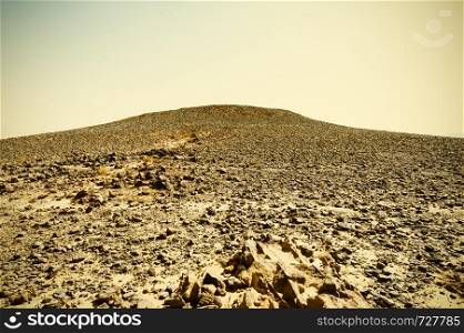 Breathtaking landscape of the rock formations in the Israel desert. Dusty mountains interrupted by wadis and deep craters. Vintage Style Desert