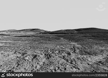 Breathtaking landscape of the rock formations in the Israel desert in black and white. Lifeless and desolate scene as a concept of loneliness, hopelessness and depression.