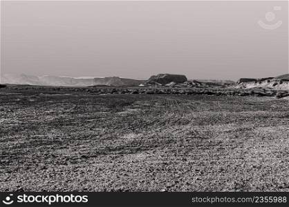 Breathtaking landscape of the rock formations in the Israel desert in black and white. Lifeless and desolate scene as a concept of loneliness, hopelessness and depression.
