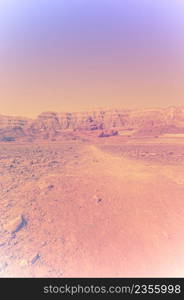 Breathtaking landscape of the rock formations in the Israel desert in faded color effect. Lifeless and desolate scene as a concept of loneliness, hopelessness and depression.