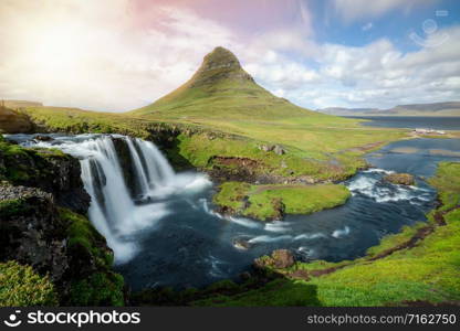 Breathtaking sunrise over Kirkjufell mountain landscape and waterfall in Iceland summer. Kirjufell is the beautiful landmark and the most photographed mountain which attracts tourist to visit Iceland.