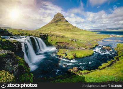 Breathtaking sunrise over Kirkjufell mountain landscape and waterfall in Iceland summer. Kirjufell is the beautiful landmark and the most photographed mountain which attracts tourist to visit Iceland.