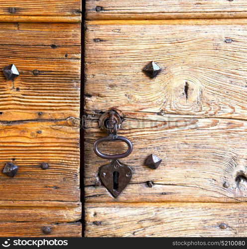 brebbia abstract rusty brass brown knocker in a door curch closed wood italy lombardy