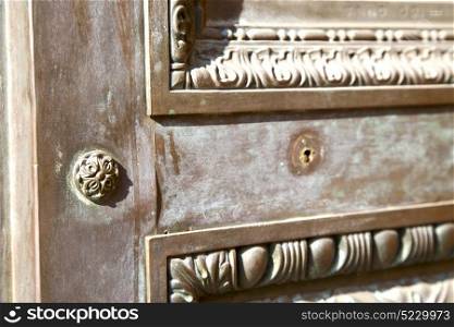 brebbia abstract rusty brass brown knocker in a door curch closed wood italy lombardy