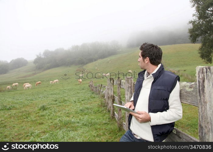 Breeder using electronic tablet in field