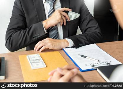 Bribery and corruption, Businessman hand giving money and receive in the envelope offered file Dishonest cheating in business illegal money concept