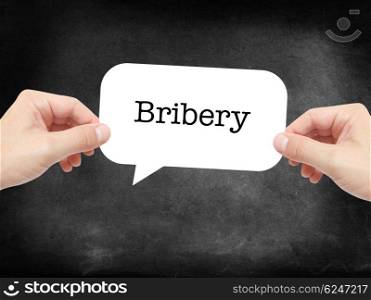 Bribery written on a speechbubble