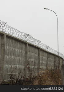 brick fence with barbed wire