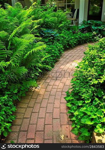Brick path in landscaped garden