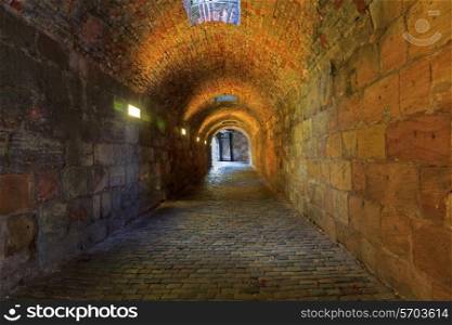 Brick tunnel with light in the end&#xA;