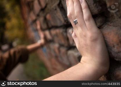 brick wall and girls hands - confrontation
