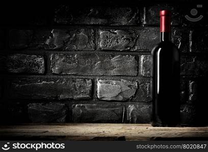 Brick wall in cellar and bottle of cabernet