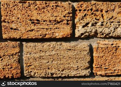 Brick wall of yellow shell rock. Closeup of shellstone texture. Background.