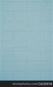 Brick wall painted with a blue paint, closeup background.
