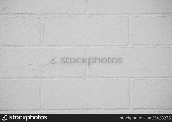 Brick wall painted with a white paint, closeup background.