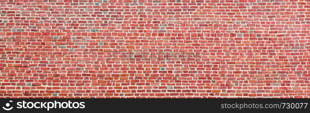 Brick wall, wide panorama of bright red masonry. Wall with small Bricks. Modern wallpaper design for web or graphic art projects. Abstract template or mock up.. Brick wall, wide panorama of masonry. Wall with small Bricks