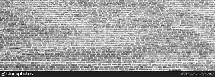 Brick wall, wide panorama of gray masonry. Wall with small Bricks. Modern wallpaper design for web or graphic art projects. Abstract template or mock up.. Brick wall, wide panorama of masonry. Wall with small Bricks