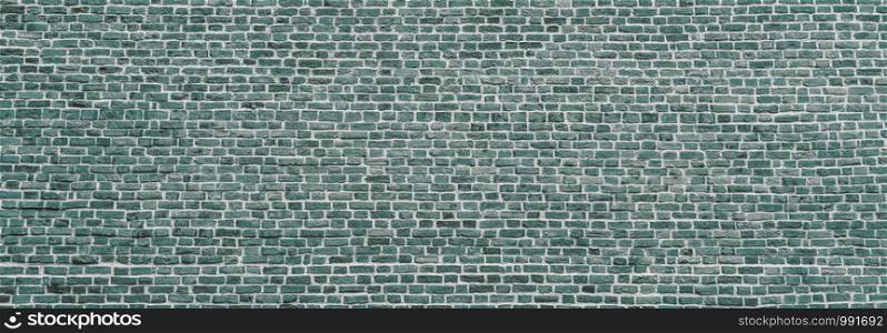 Brick wall, wide panorama of mint color masonry. Wall with small Bricks. Modern wallpaper design for web or graphic art projects. Abstract template or mock up.