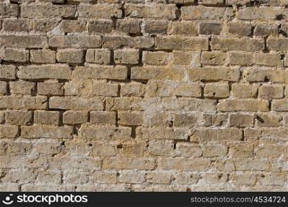 Brick wall with old stones and weathered material