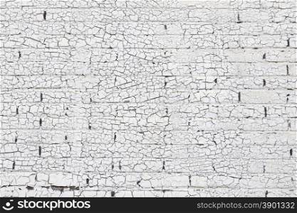 brick wall with old white paint pattern full of cracks
