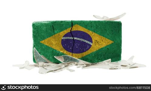 Brick with broken glass, violence concept, flag of Brazil