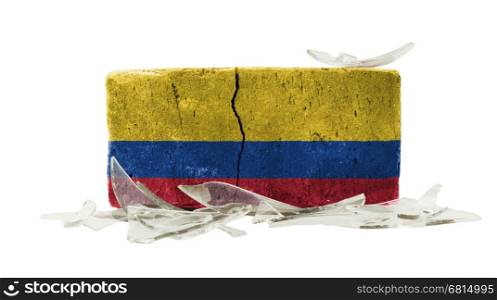 Brick with broken glass, violence concept, flag of Colombia