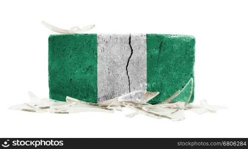 Brick with broken glass, violence concept, flag of Nigeria