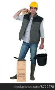 Bricklayer carrying bucket