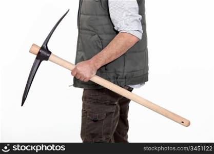 bricklayer holding pickaxe in studio