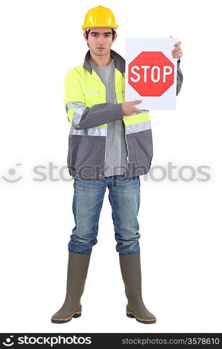 bricklayer holding stop sign