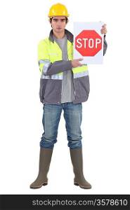bricklayer holding stop sign