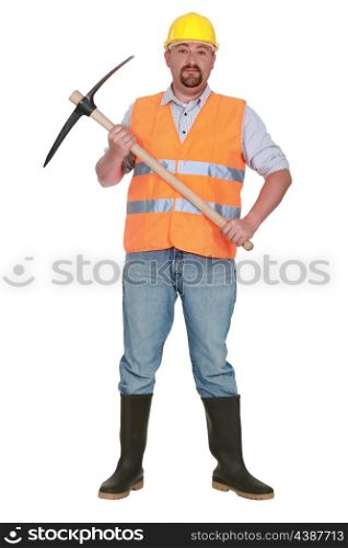 bricklayer holds pickaxe against studio background