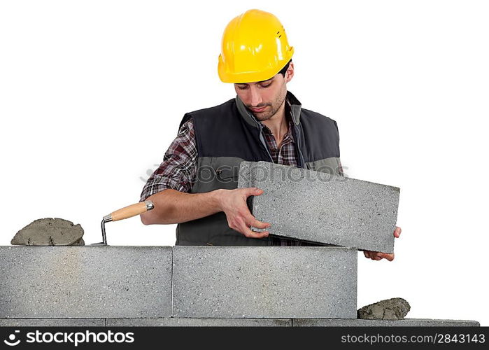 Bricklayer making a block wall
