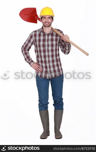 bricklayer standing against white background holding red shovel