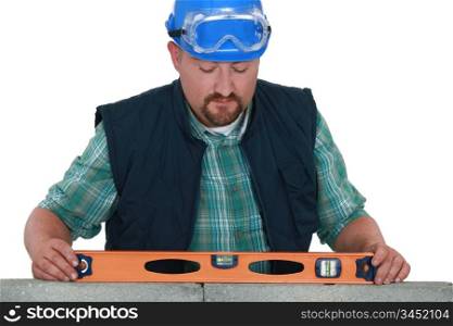 bricklayer taking measurements