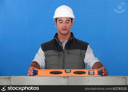 Bricklayer with a spirit level