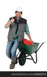 bricklayer with wheelbarrow and trowel thumb up