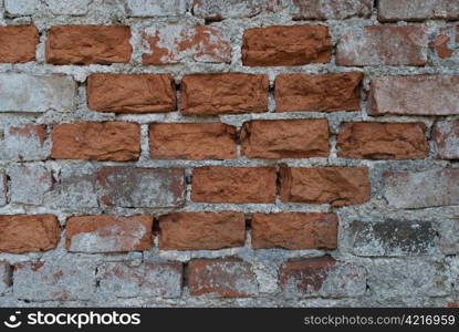 bricks coming through an old facade