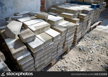 brickwork, construction and building material concept - bricks batch on wooden storage pallet
