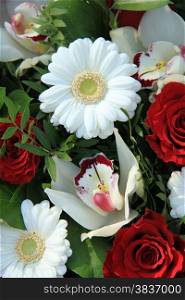 Bridal arrangement in red and white, cymbidium orchids, red roses and white gerberas