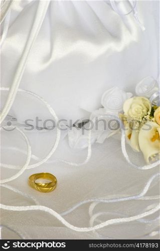 bridal bag and wedding rings flowers decorations over bridal veil