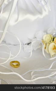 bridal bag and wedding rings flowers decorations over bridal veil