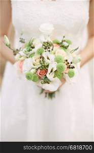 Bridal bouquet. Beautiful bouquet of different colors in the hands of the bride&#xA;&#xA;
