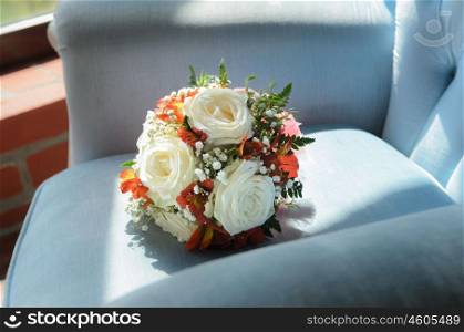 Bridal bouquet in soft antique chair from blue velvet