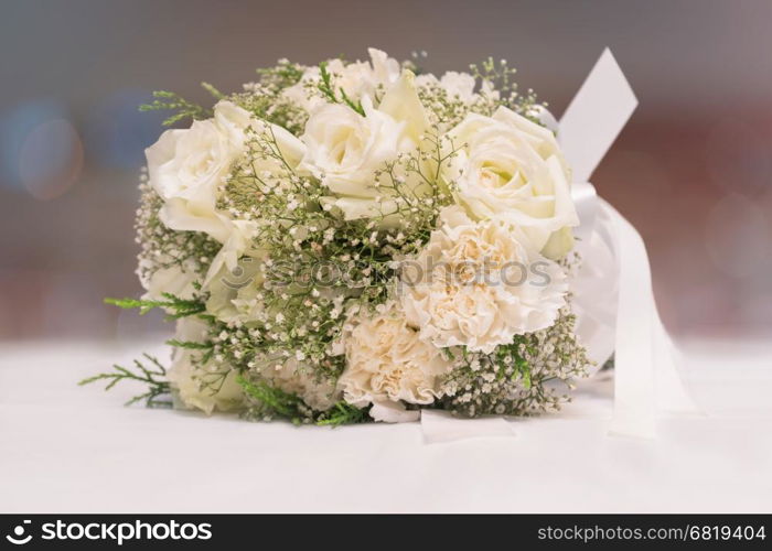 Bridal bouquet of white rose on blur background